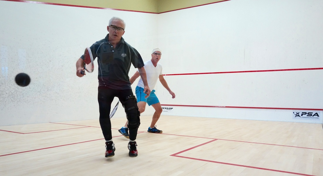 Kiva Club Open qualifying, Sept. 15, 2015. Walter Burke, left, played a shot off the back wall in his match with Tom Abrams.